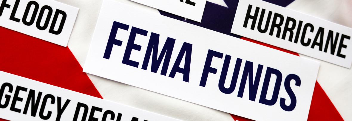 the words FEMA funds in a box appear on an American flag