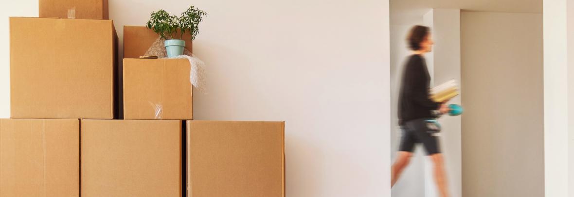 woman walking past doorway and moving boxes