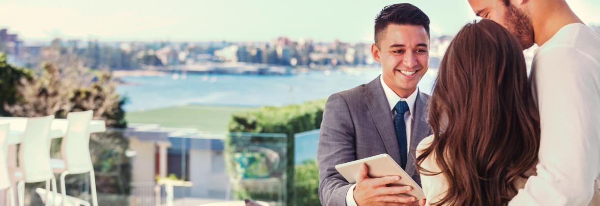 realtor and clients looking at luxury real estate