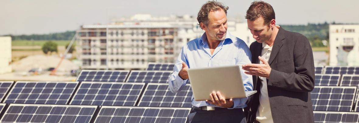men on building with solar panels