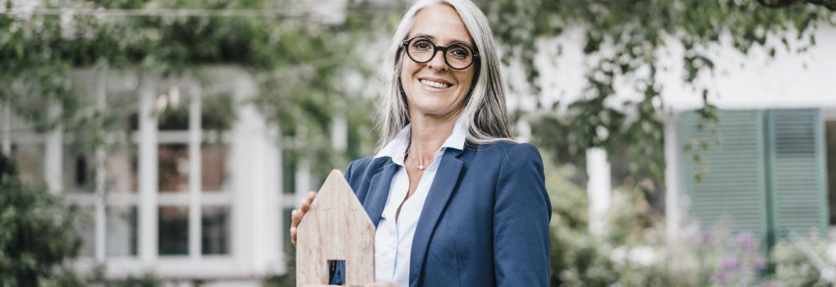 Realtor holding a model home