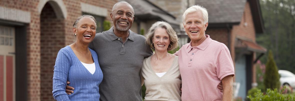 A black and white couple smile for a group photo