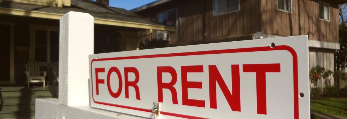 Single-family home with for-rent sign out front