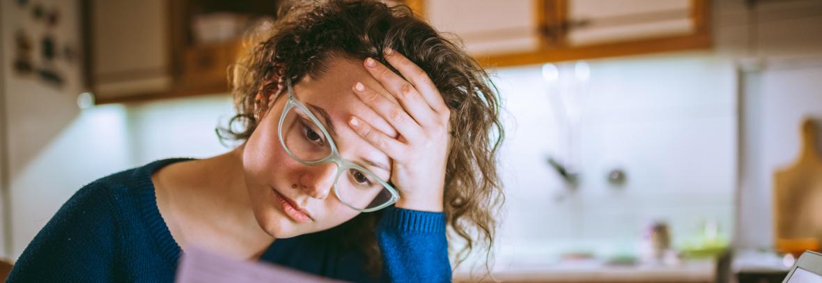 sad woman looking at bills