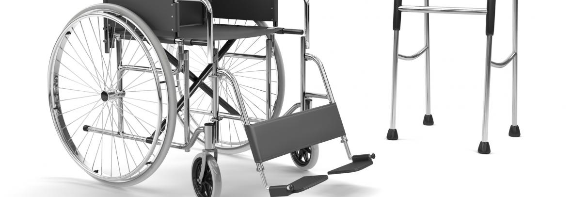 Empty wheelchair beside a walker