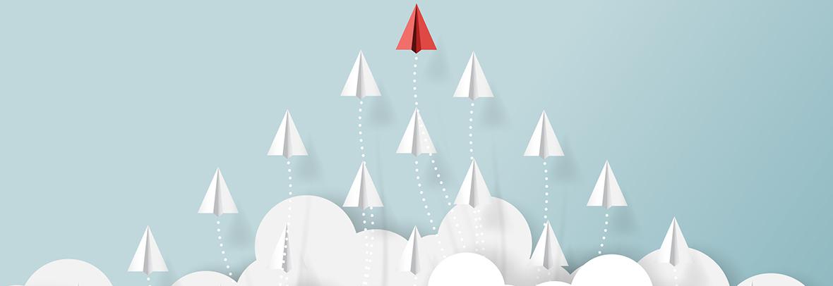 paper airplanes flying above clouds with one taking the lead