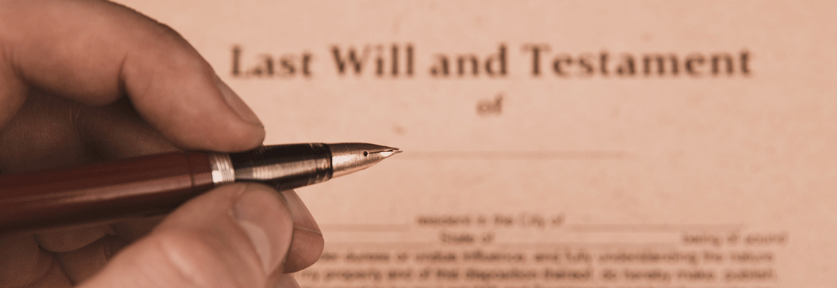 Photo of someone signing a Last Will and Testament