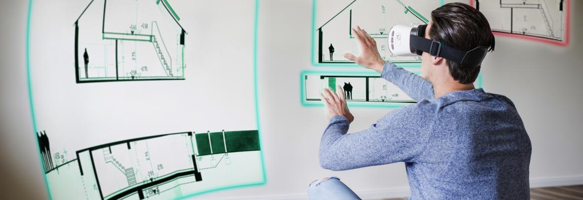 Man with 3D goggles stares at house plans