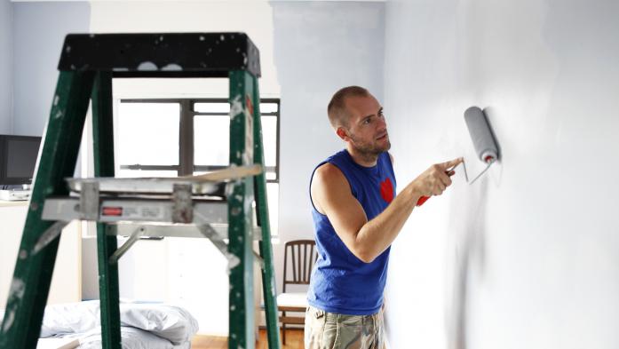 man painting a wall