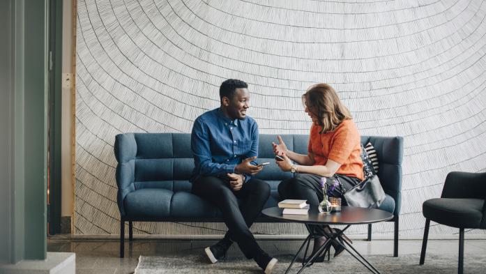 Man and woman on couch talking