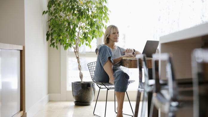 woman in kitchen using laptop