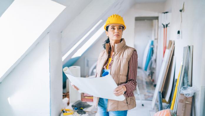 Woman studies chart during drywall installation