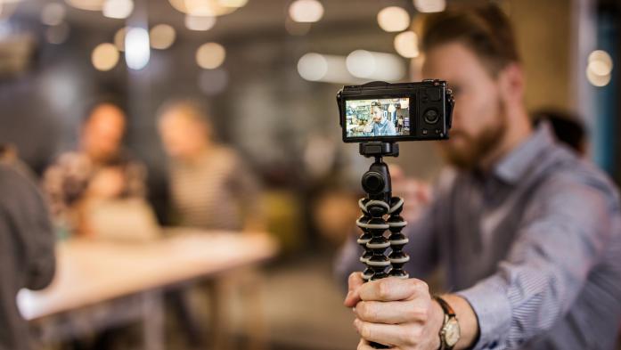 Close up of redhead man making reportage by vlogging.