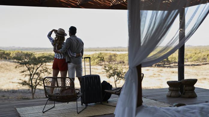 Couple under outdoor canopy with suitcases