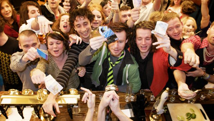 Group of eager buyers holding out credit cards