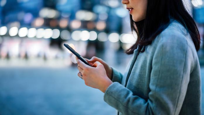 woman looking at cell phone