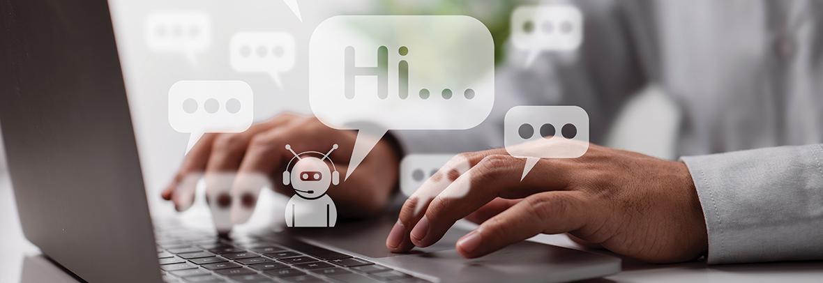 Photo of a persons hands on a computer keyboard and little white chatbot saying Hi