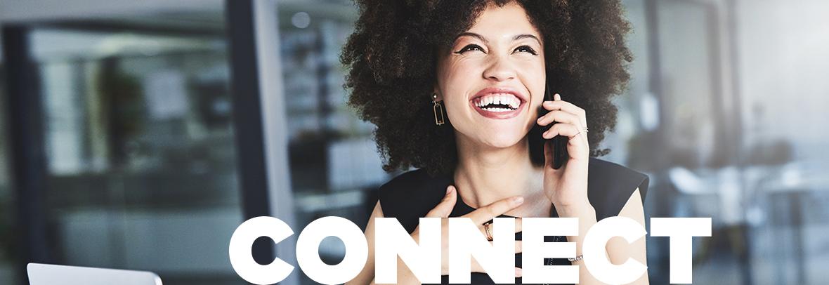 Photo of a woman with a big smile while talking on the phone