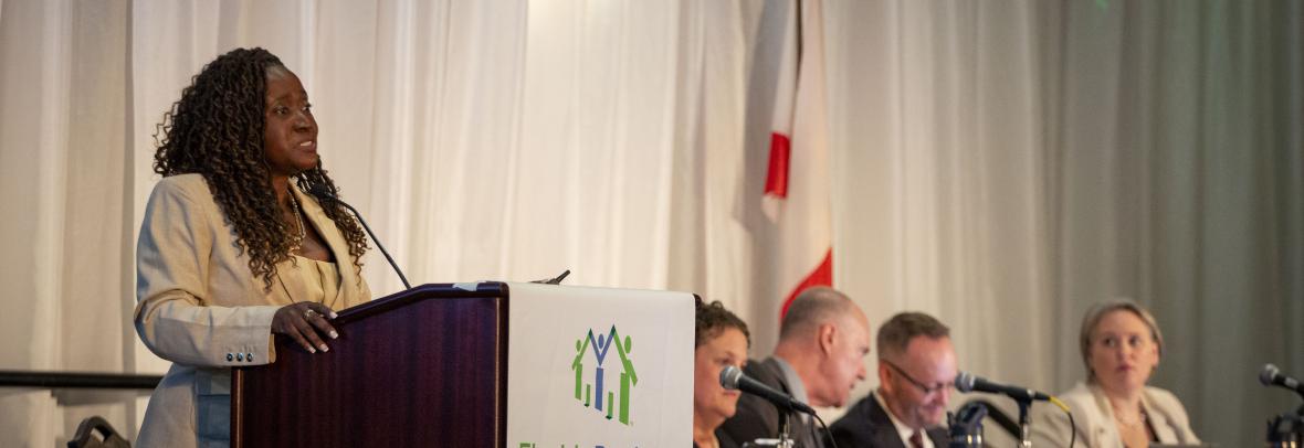 Juana Watkins and Florida Realtors legal team at 2025 Florida Realtors convention. Juana at podium 