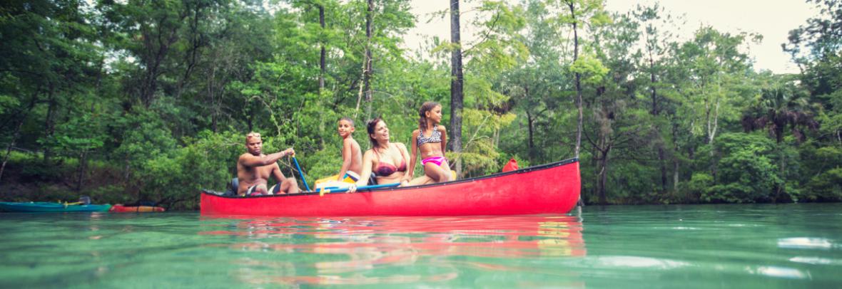 family canoeing on river
