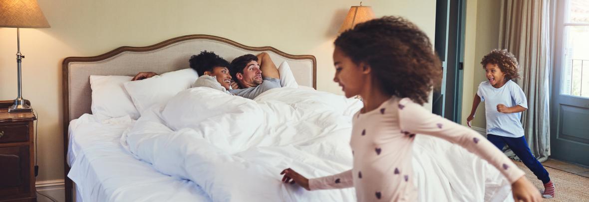 kids running around parents in bed