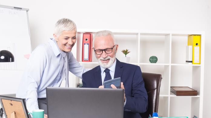 Photo of mature couple using a calculator