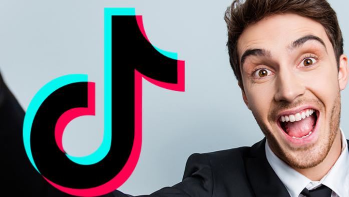Photo of a business man make a selfie video with the TikTok logo 