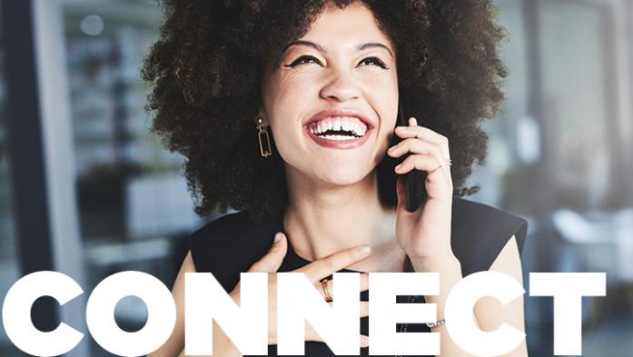 Photo of a woman with a big smile while talking on the phone