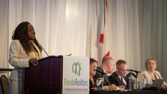 Juana Watkins and Florida Realtors legal team at 2025 Florida Realtors convention. Juana at podium 