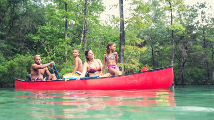 family canoeing on river