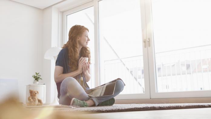 young woman looking out window