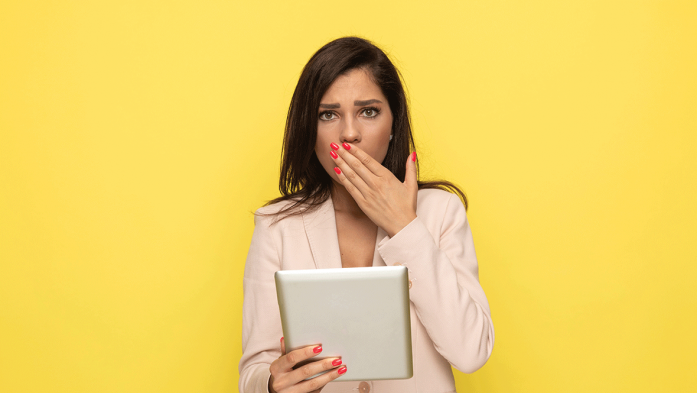 Photo of woman with hand over her mouth with a surprised expression